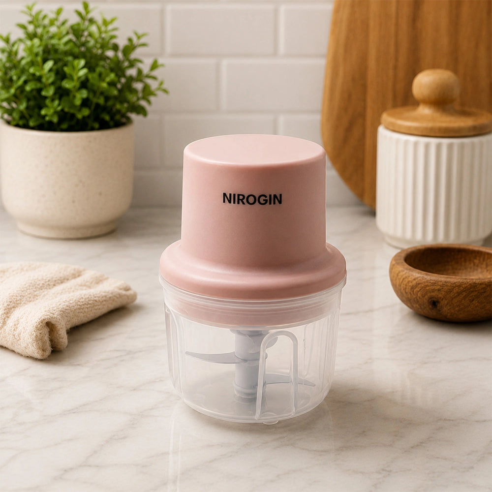 Nirogin Rechargeable Vegetable Chopper with pink lid and transparent bowl on kitchen counter.